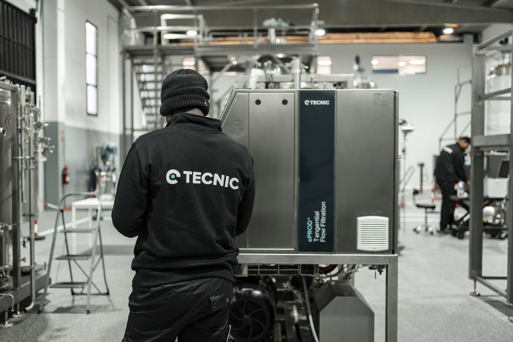 A technician working with industrial production equipment